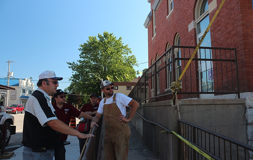 sign installation crew at old post harriston