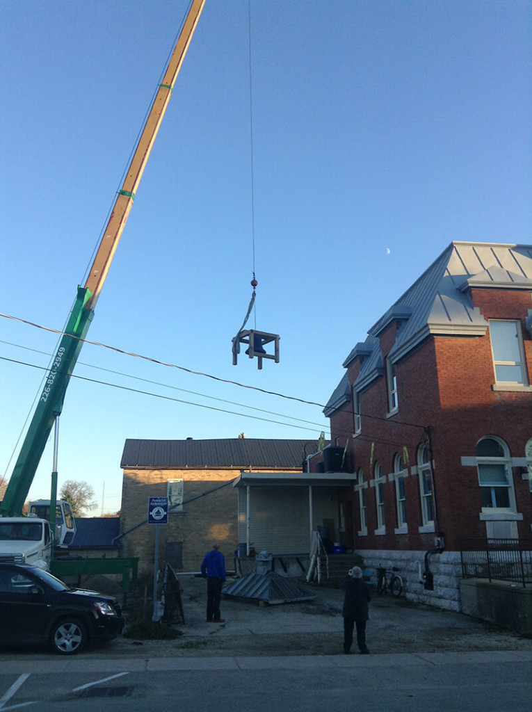 bell hoisted onto roof of harriston old post office