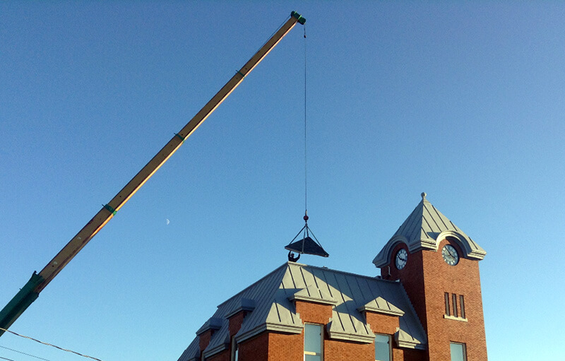 skylight hoisted onto roof of harriston old post office