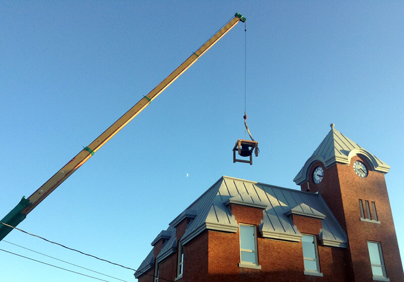 bell hoisted to roof of harriston old post office