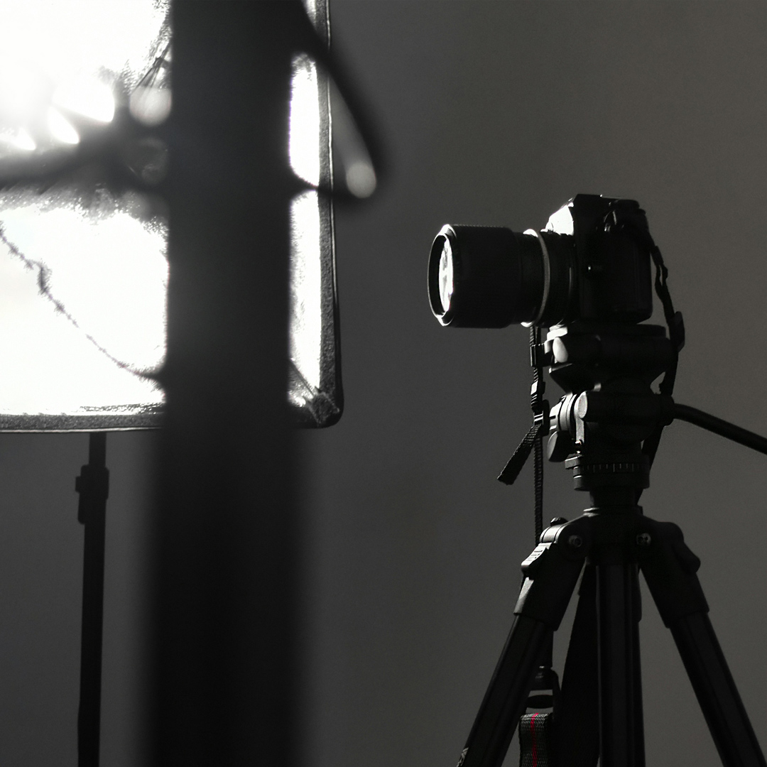 Black and white image of camera on photography set